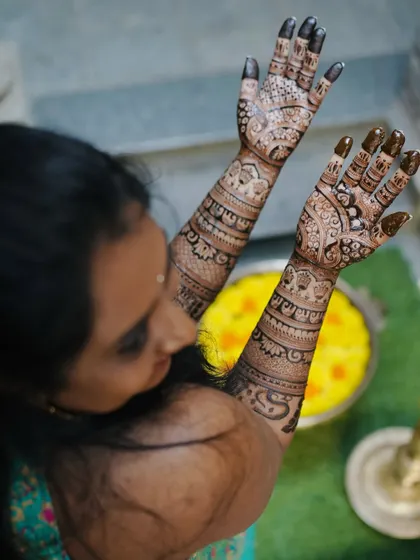 A beautiful shot of the bride's hands over her shoulder, showing the intricate back-of-hand design.