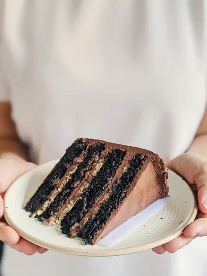 While the outside is what you see first, what's inside is just as important to me. This is a slice of my heirloom chocolate cake, a recipe passed down through generations, showing the rich layers that make every bite memorable.