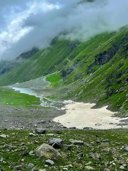 A view of the Hampta Pass trail, with a patch of snow even in September, showing the high-altitude nature of the trek.