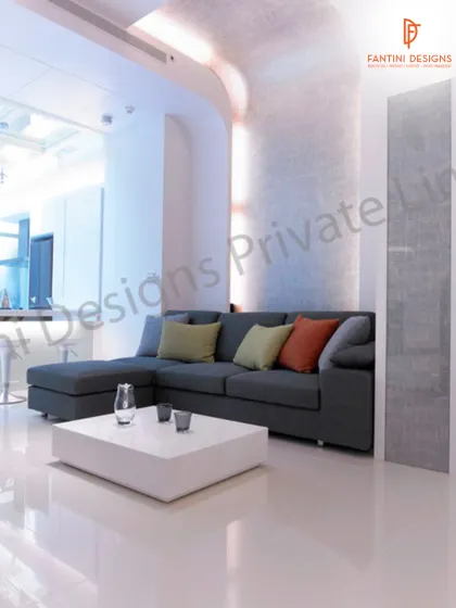 A comfortable L-shaped sofa with colorful cushions adds a pop of warmth to this otherwise minimalist and modern living room. It shows how I balance clean aesthetics with livable comfort.