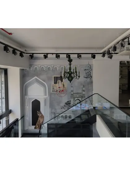 Another view of the Puma mural in its architectural context, showing the interplay between the art, the glass railing, and the store lighting.
