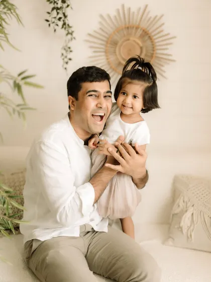 The pure joy of a father playing with his daughter. His laugh is infectious in this shot.