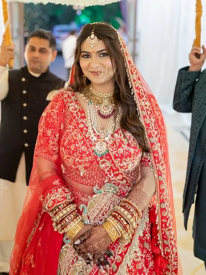 The bride's entrance, looking serene and beautiful. Her makeup is designed to photograph beautifully, capturing her glow in every shot.