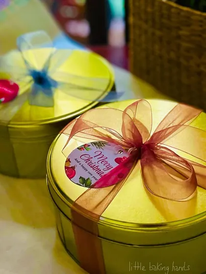 My Christmas cakes come in these beautiful, reusable tins, making them a perfect gift. I love adding the final touches with ribbons and tags.