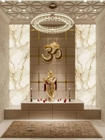 This pooja room design exudes modern luxury with a prominent gold Om symbol against a marble-veined backdrop. The walls feature intricate 3D textured patterns, and a contemporary ring chandelier provides brilliant illumination for the entire space.