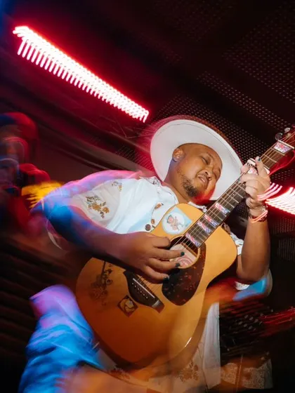 An artistic, motion-blur shot of me playing guitar on stage. This image captures the high energy, movement, and electric feeling of a live performance.