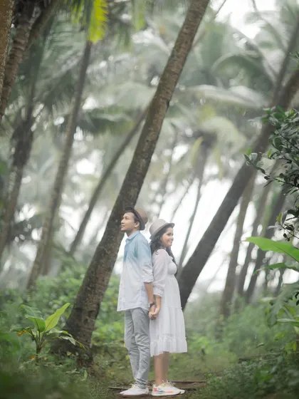A romantic pose amidst a grove of palm trees, creating a lush, tropical feel for this pre-wedding photo.