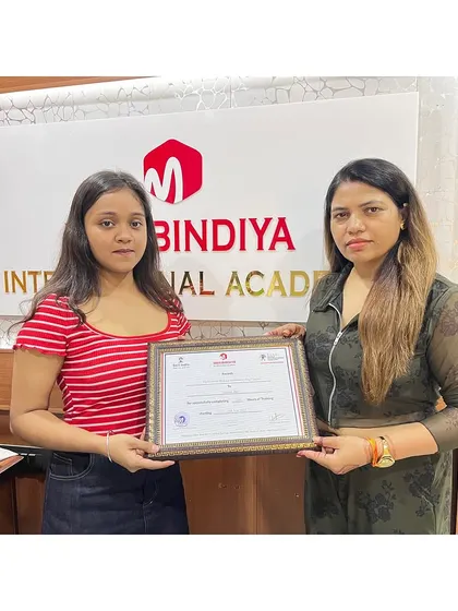 A happy and proud moment for this student as she receives her professional certification.
