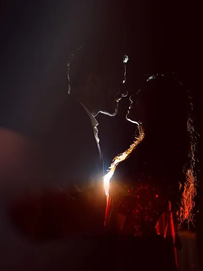 A beautiful silhouette of the couple against a soft light, creating a romantic and artistic portrait.