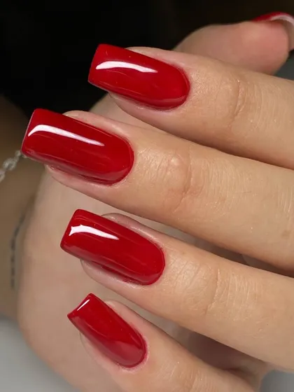 A bold, classic red on perfectly sculpted square extensions. The flawless application and glossy finish highlight the quality of our work.