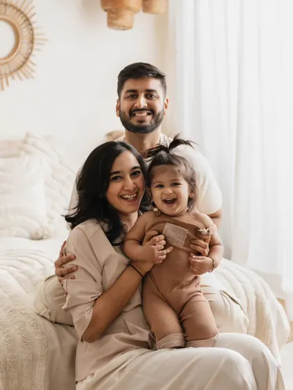This is what pure joy looks like! I love capturing these candid, laughing moments during my family lifestyle sessions. This photo, taken in my boho-themed studio setup, shows how fun and relaxed a family photoshoot can be.