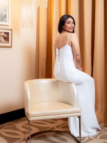 The back of Sapthami Gowda's white gown featured a modern corset-style tie-up, adding a unique detail to the elegant look.