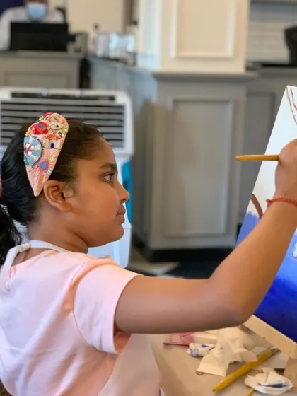 Another young participant at the Kochi workshop, carefully adding details to her painting.