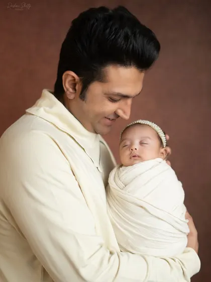 A father's gentle and loving gaze as he holds his sleeping newborn. These are the quiet moments that speak volumes.
