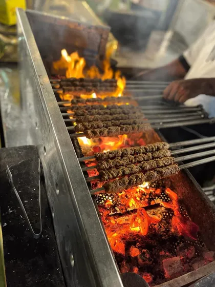 Rows of perfectly charred seekh kebabs on the grill, ready to be served.