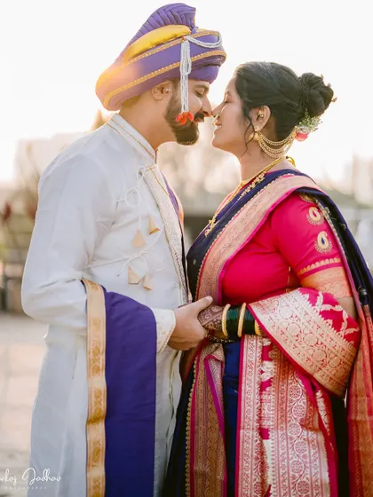 A romantic close-up of the couple, their faces close together, bathed in golden light.