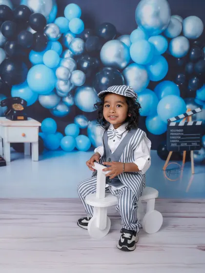 A big smile from the birthday boy on his tricycle. These action shots are perfect for capturing the energy of a toddler.