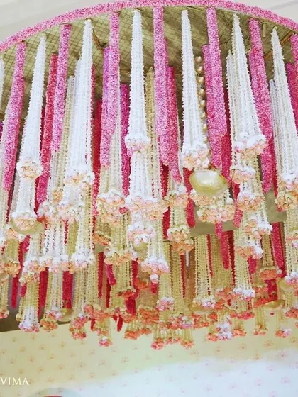 An enchanting chandelier made entirely of fragrant jasmine (mogra) and delicate pink lotuses. This was a stunning centerpiece for a traditional half-saree function, filling the air with a beautiful scent.