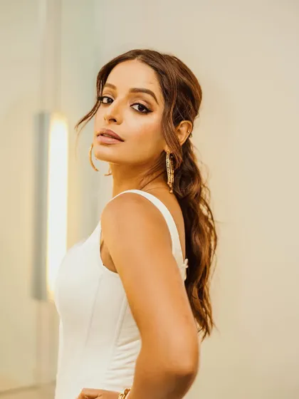 A beautiful close-up of Lisa, highlighting her glowing makeup and the elegant lines of the white corset dress.
