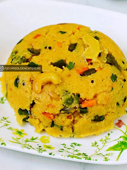 A serving of our delicious vegetable Upma, cooked with semolina, mixed vegetables, and cashews. This is a wholesome and comforting breakfast option.