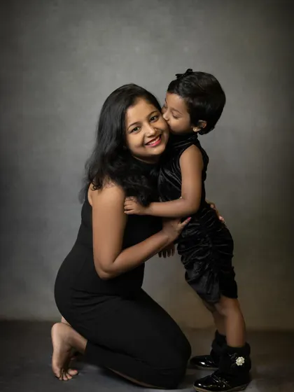A sweet kiss on the cheek from daughter to mom. These are the simple, loving gestures that create the most heartwarming mother-daughter portraits.