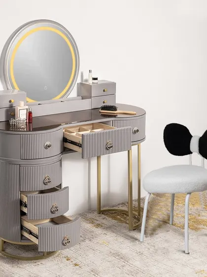 A new addition to our collection, this grey dressing table and vanity set features a round LED mirror and a cute bow-tie chair. The drawers are open to showcase the extensive storage capacity.