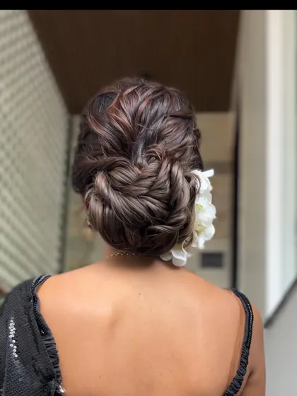 This version of the textured bun is adorned with fresh flowers, showing how the same style can be adapted for different looks.