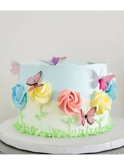 Tell me your theme and I'll bring it to life. This beautiful butterfly garden cake is a perfect example of a fondant-free creation that is both colorful and delicious.