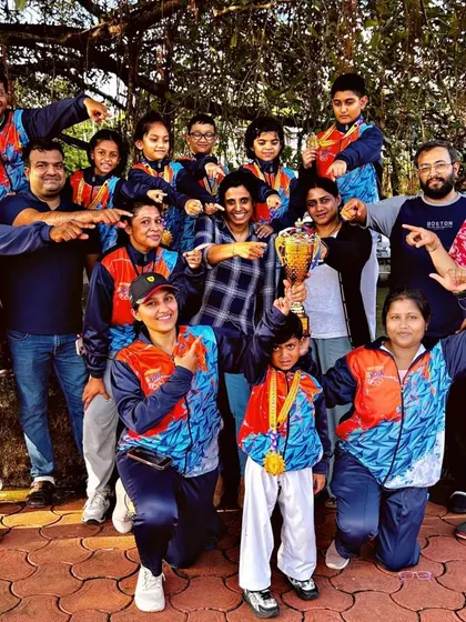 The celebration of success is a community affair. Here, our students, coaches, and supportive parents celebrate a major win together, showcasing the strong family spirit at NMFA.