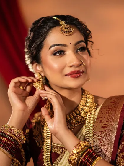 This shot focuses on the delicate details of the jhumkas and the intricate design of the necklace. My collection is filled with such beautifully crafted pieces available for rent.