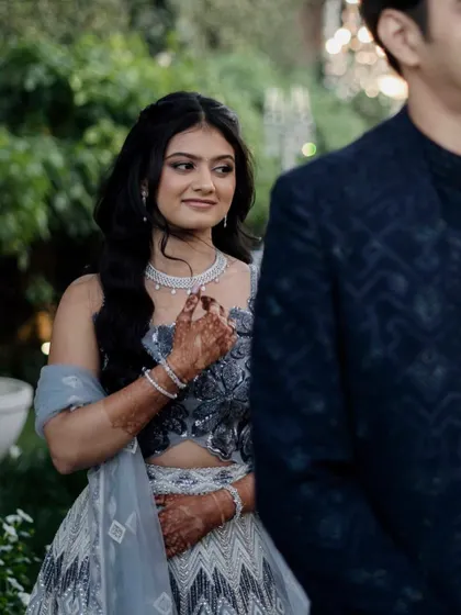 The bride looking at her groom during their engagement. Her makeup is a beautiful soft glam, with a defined eye and neutral lip, letting her happiness shine.