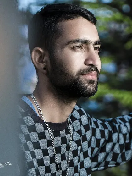 A candid-style portrait with a natural frame. Using elements in the foreground like this adds depth and interest to the photo.