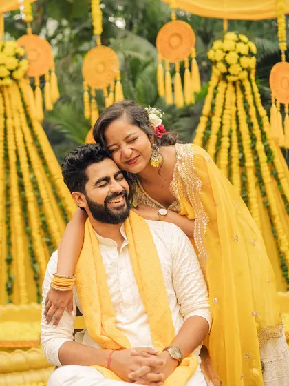 An intimate hug against a backdrop of marigold decorations. I focus on composition and color to make every frame of your wedding story feel like a piece of art.