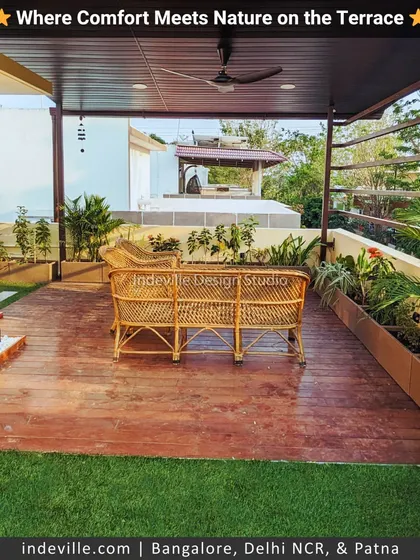 A complete view of a cozy terrace I designed. It features a combination of artificial turf and a wooden deck, a small water feature, cane seating, and planters, all under a shaded roof with a fan for added comfort.