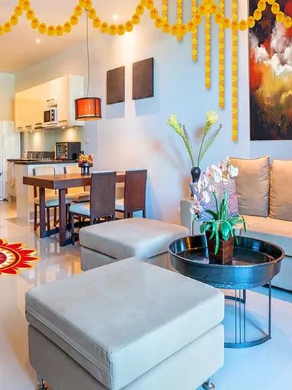 A beautiful living space decorated for a celebration, showing how our designs provide a perfect canvas for personal touches. The open layout connects the living and dining areas, making it ideal for hosting guests.