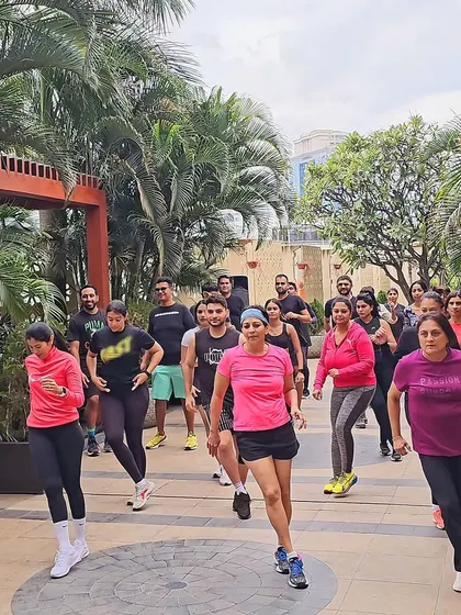 The team jogging in place during a cardio segment. I incorporate a variety of movements to keep the sessions engaging and effective.