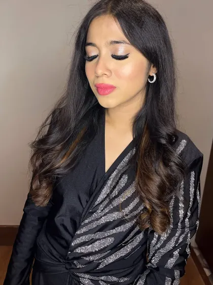The eye makeup details are key for this glam look, with a bright silver shimmer on the lid.