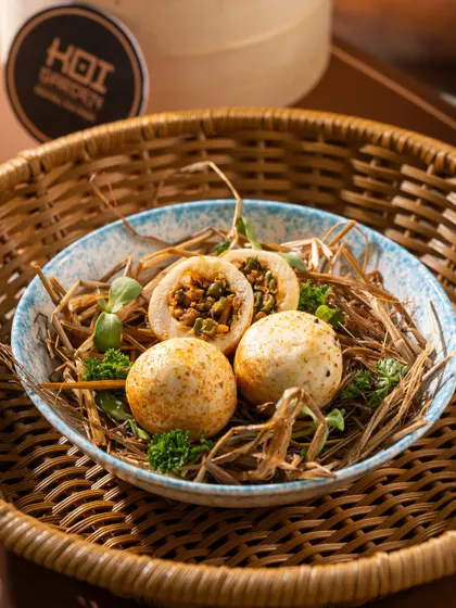 A creative presentation of stuffed rice balls in a nest. This kind of unique plating is great for catching a customer's eye.