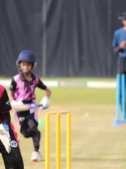 A U-10 wicketkeeper and batter in action during a practice match.