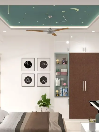 A creative kid's bedroom with a false ceiling painted to look like a starry night sky. The room includes a study desk, a keyboard stand, and a wardrobe with a built-in open display shelf.