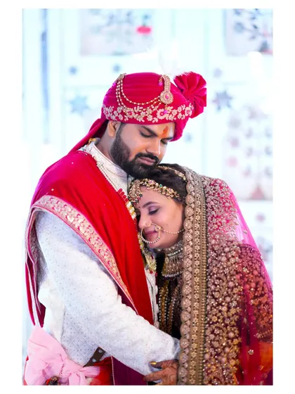 An emotional and tender moment, with the bride resting her head on the groom's chest. This image is full of love, trust, and the promise of a shared future.