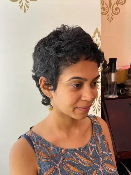 The final result: a modern curly mullet for Aditi. This cut is edgy, stylish, and embraces her natural texture.