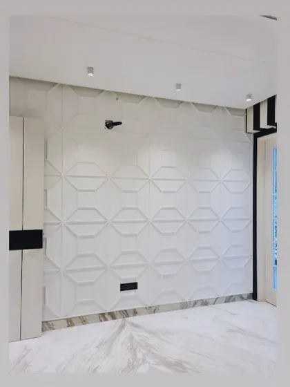 This wall is packed with personality. A 3D geometric panel in pure white adds texture and a modern, artistic feel to the space.