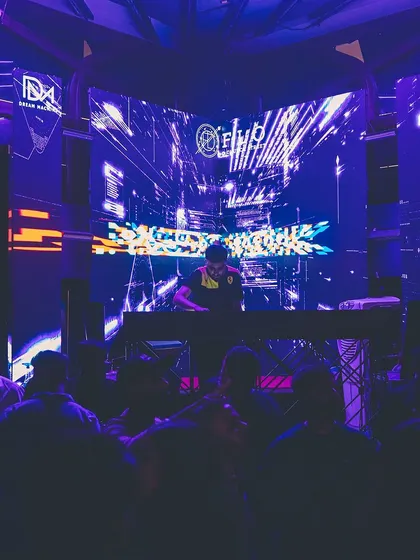 Another view of me at the decks, framed by the club's architecture and lighting. The environment is a huge part of the vibe.