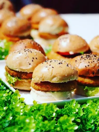 Our mini veg sliders served on a bed of fresh greens, a healthy and delicious appetizer choice.