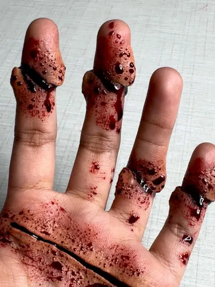 A final shot of the SFX hand makeup, showcasing the realistic effect of the severed fingers.