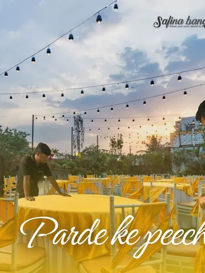 Another "Parde ke peeche" shot, showing our team setting up the dining tables for an outdoor event at dusk.