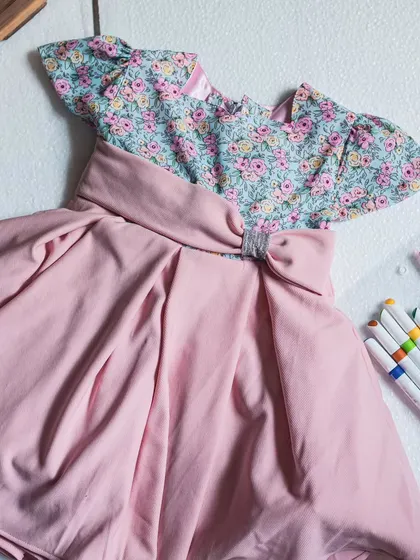 A flat-lay of the dusty pink and floral dress, showcasing the beautiful color combination and thoughtful design.
