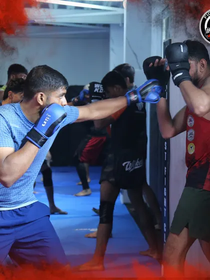 National team members practicing their boxing combinations. The sound of gloves hitting pads filled the gym as these fighters sharpened their striking.