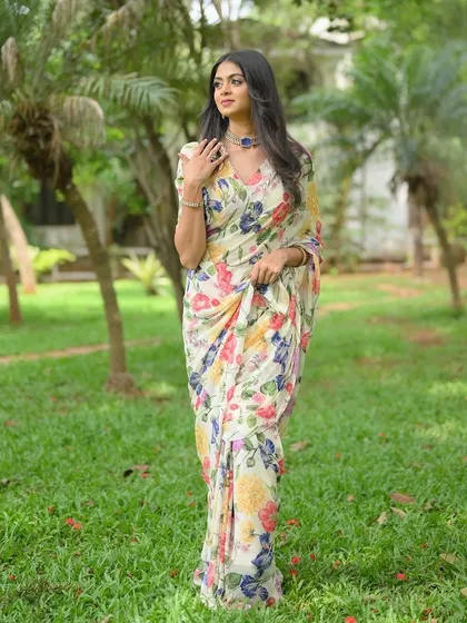 A white floral chiffon saree, a masterpiece of grace and elegance.